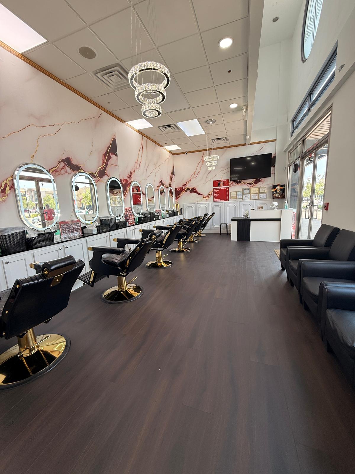 Interior of Eyebrow Threading & Beauty salon — marble walls, crystal chandeliers, and styling chairs in Northfield, Denver